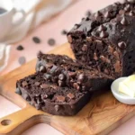Sliced Chocolate Cake Mix Bread with chocolate chips on a wooden board with butter