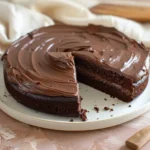 Homemade chocolate sheet cake with glossy fudge frosting and a slice removed.Easy Chocolate Cake Section