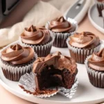 Chocolate cupcakes with frosting made in an air fryer, showing moist interior and crisp top air fryer chocolate cupcakes