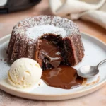 Chocolate lava cake made in an air fryer with molten center flowing onto plate, served with ice cream.air fryer chocolate lava cakes