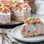 Fruity Pebbles cheesecake slice served on plate