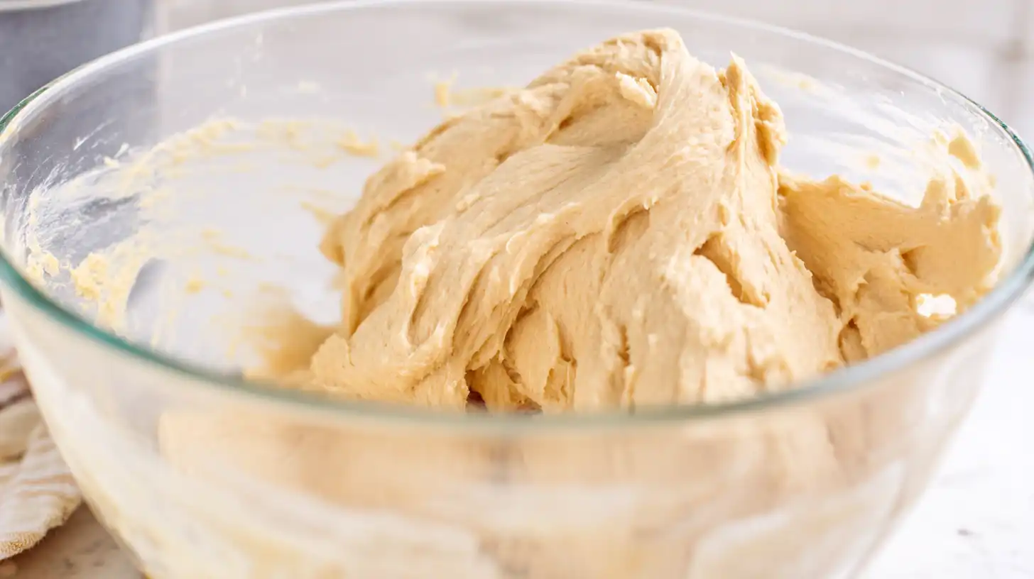 step2-apricot-cake-batter-mixing Apricot cake batter in a large glass bowl, whipped smooth and fluffy. Step 2 in Mary Berry apricot cake recipe. Ideal for home baking for beginners and classic British cake recipes with fruit.