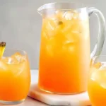 glass pitcher and glasses of Summer Pineapple Lemonade Punch with ice