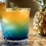 layered bikini bottom punch shot in glass with garnish
