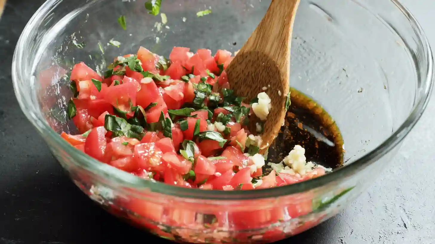 classic-italian-bruschetta-recipe-step1 Mixing tomatoes and basil for classic Italian bruschetta recipe