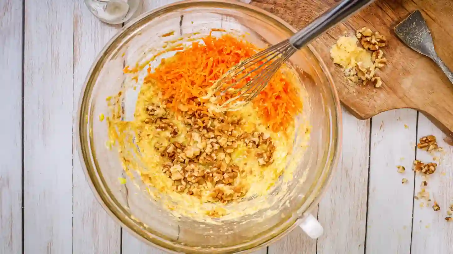 combine-fold-carrot-pineapple-cake-batter Folding pineapple and carrots into carrot cake batter