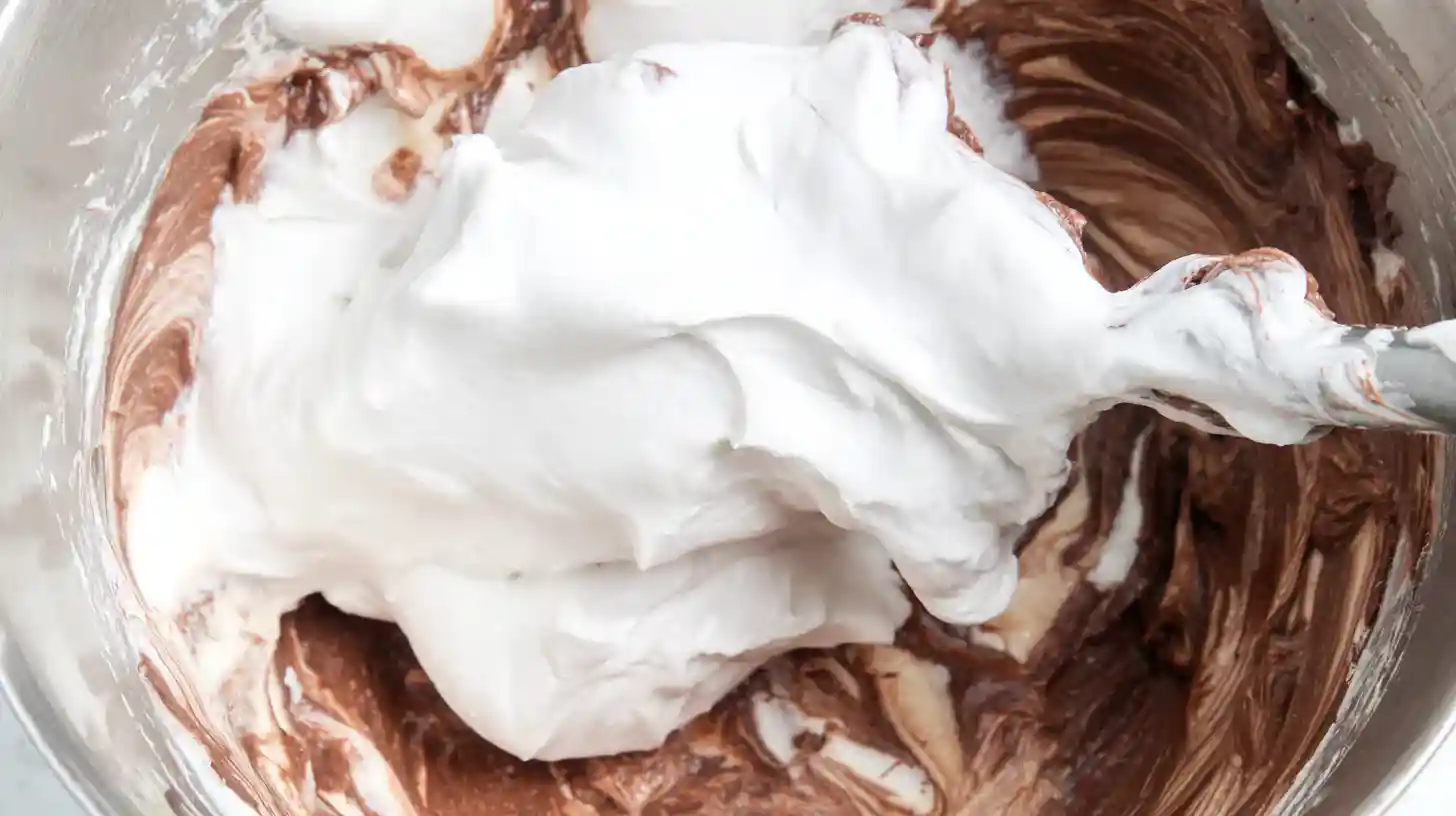 folding-cool-whip-reeses-frosting Folding Cool Whip into peanut butter pudding base