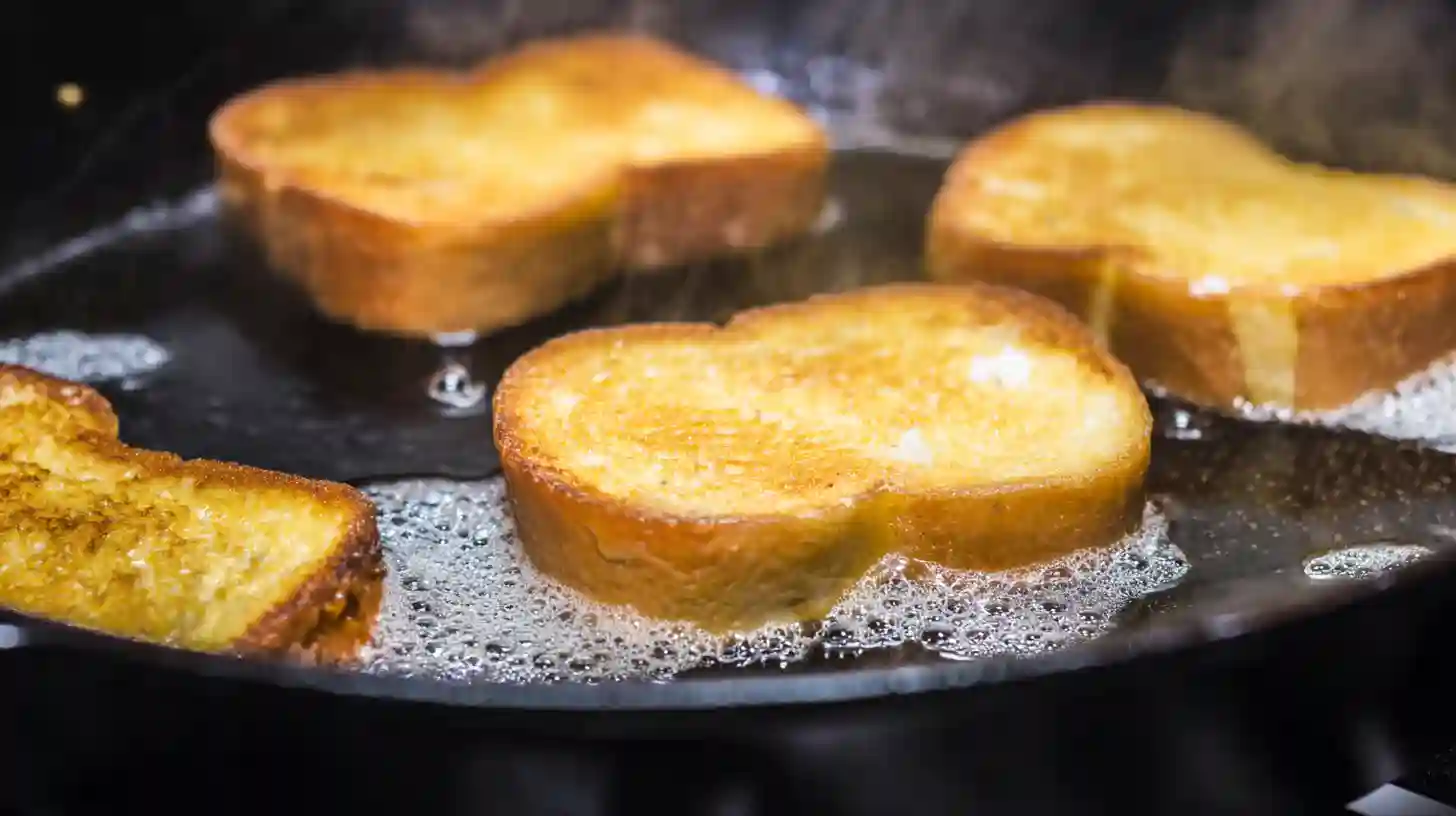 frying-cheesecake-sandwiches Cooking strawberry cheesecake sandwiches in skillet