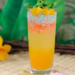 Kaccha Mango Bite Mojito served in a tall glass with mint