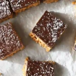 Muddy Buddy Rice Krispies Recipe bars dusted with powdered sugar