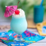 Ocean blue piña colada with whipped cream and cherry