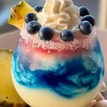 servid Ocean Love Colada Recipe Easy served in a tropical beach setting