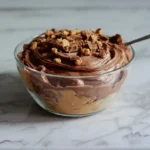 Reese s Swirl Cool Whip and Pudding Frosting in bowl with candy topping