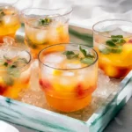 Glasses of Ocean Peach Punch served on a summer tray