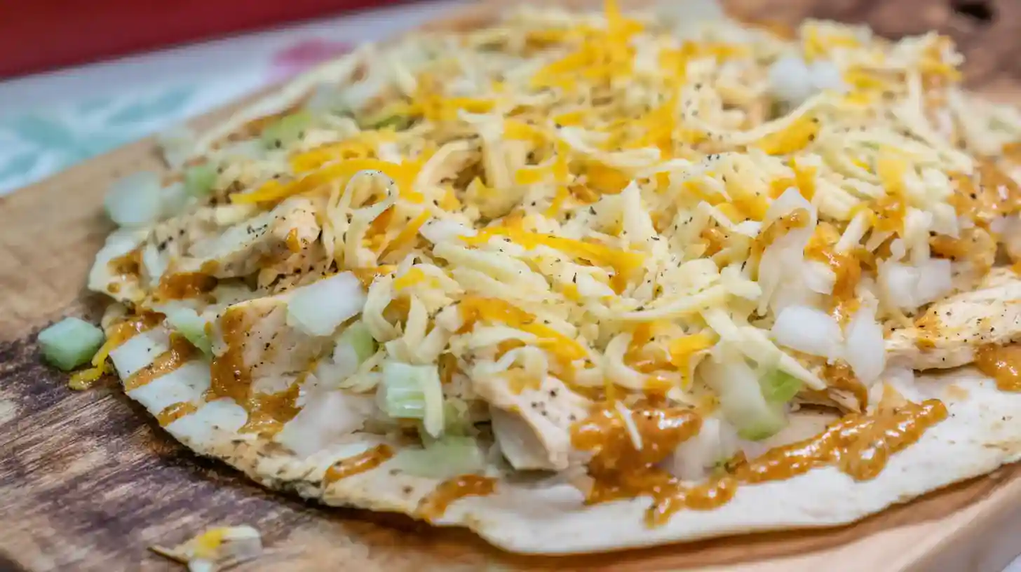simple-cheesy-garlic-chicken-wraps-step2 Assembling Simple Cheesy Garlic Chicken Wraps with sauce, chicken, and cheese