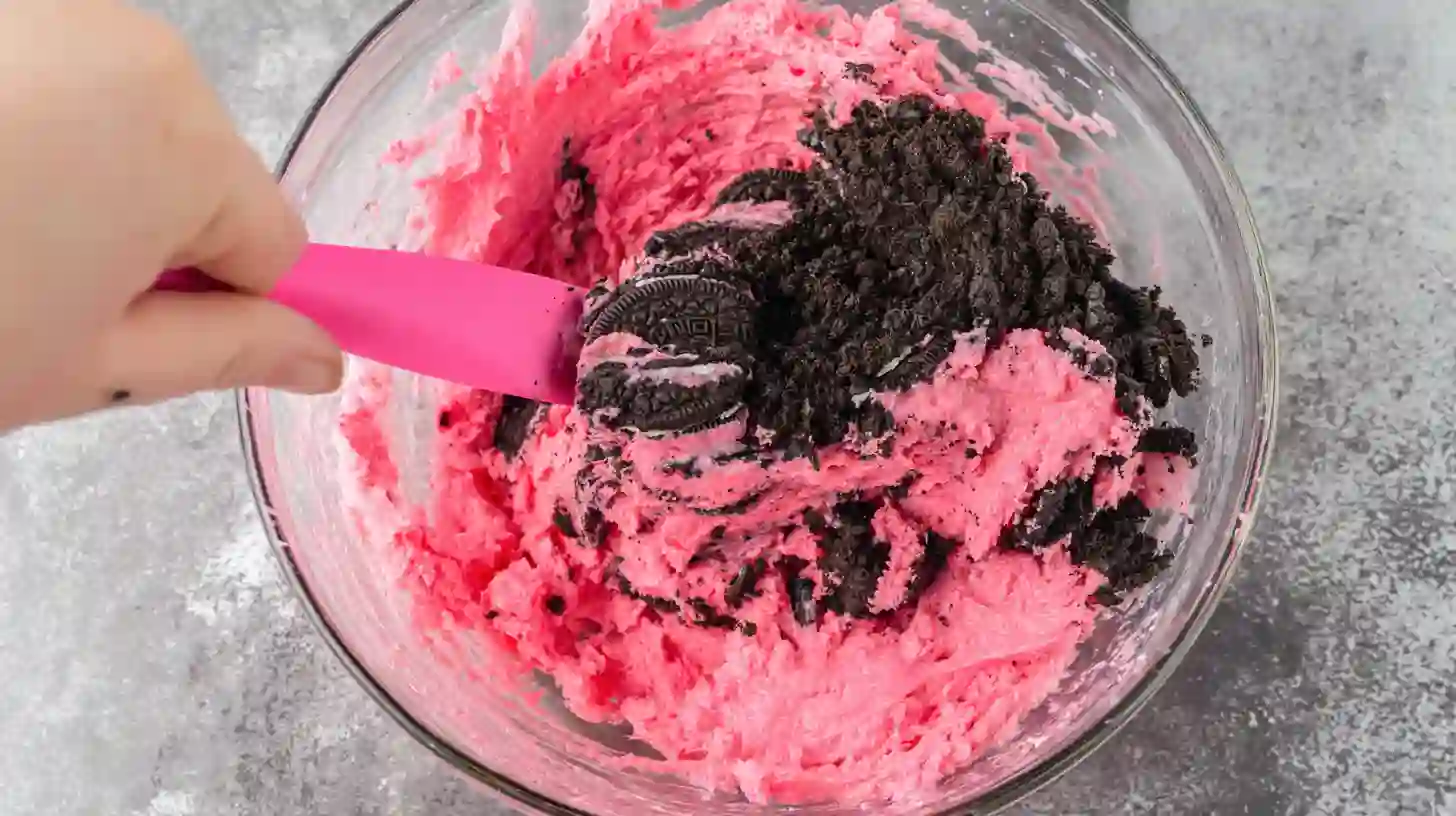 step1-mixing-strawberry-oreo-batter Strawberry cake batter being folded with Oreo cookies