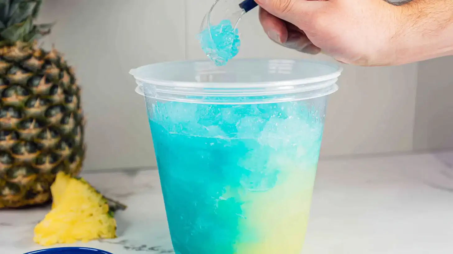 stirring-mermaid-cocktail-in-bucket Stirring Malibu Mermaid Bucket Cocktail layers
