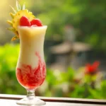 layered strawberry piña colada lava flow in glass