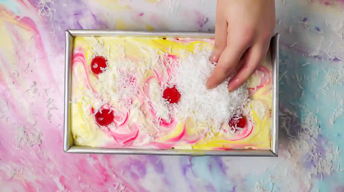 bahama-mama-ice-cream-top-and-freeze steep5 Bahama Mama Ice Cream topped with coconut and cherries before freezing – tropical dessert recipes and homemade ice cream without a machine