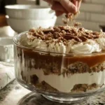 chilled pecan pie cheesecake trifle topped with whipped cream and pecans for easy holiday dessert