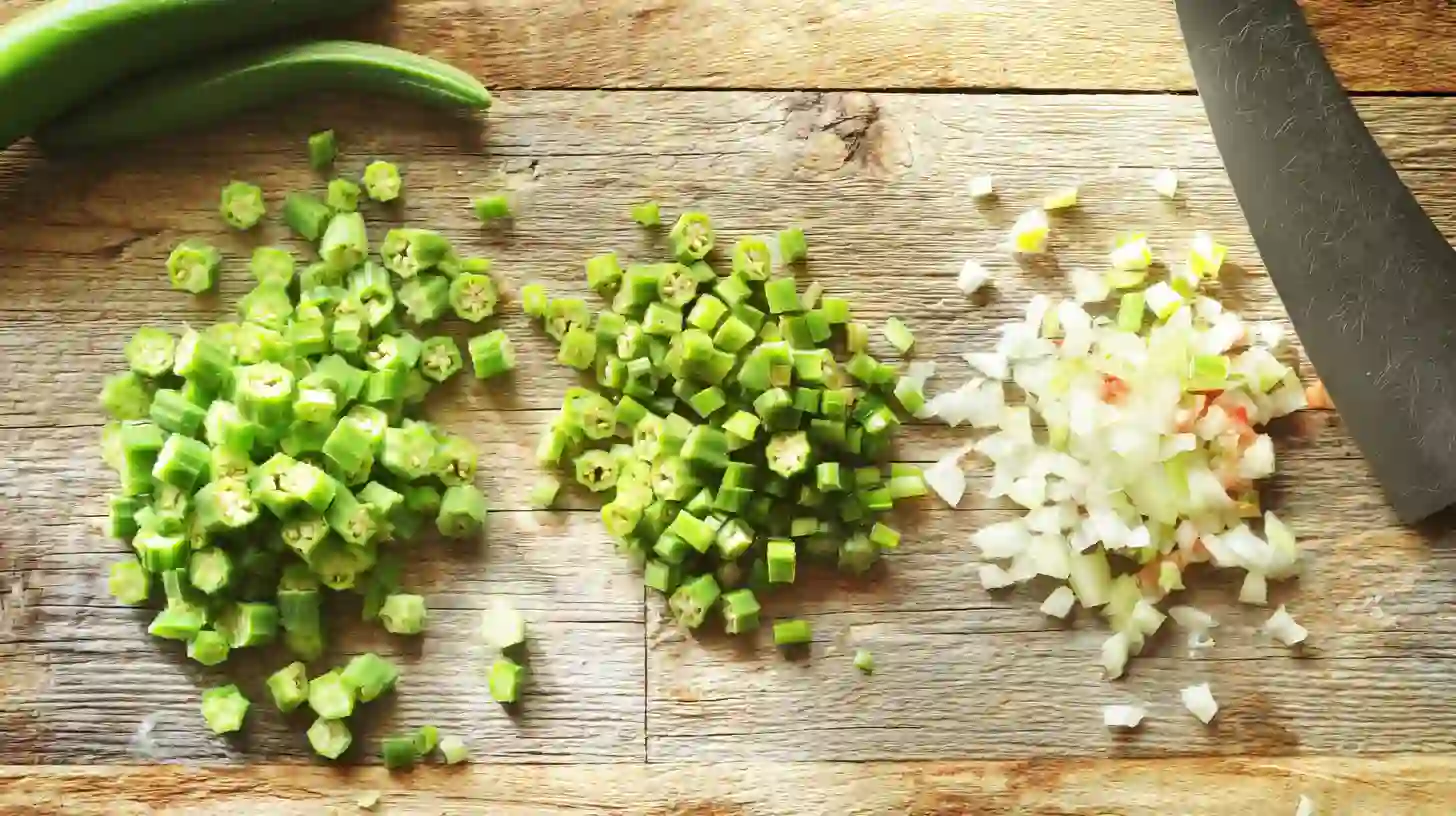 chopping-okra-green-tomato-onion Chopped okra, green tomato, and onion on cutting board