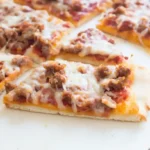 Sliced Homemade School Pizza Recipe resting before serving