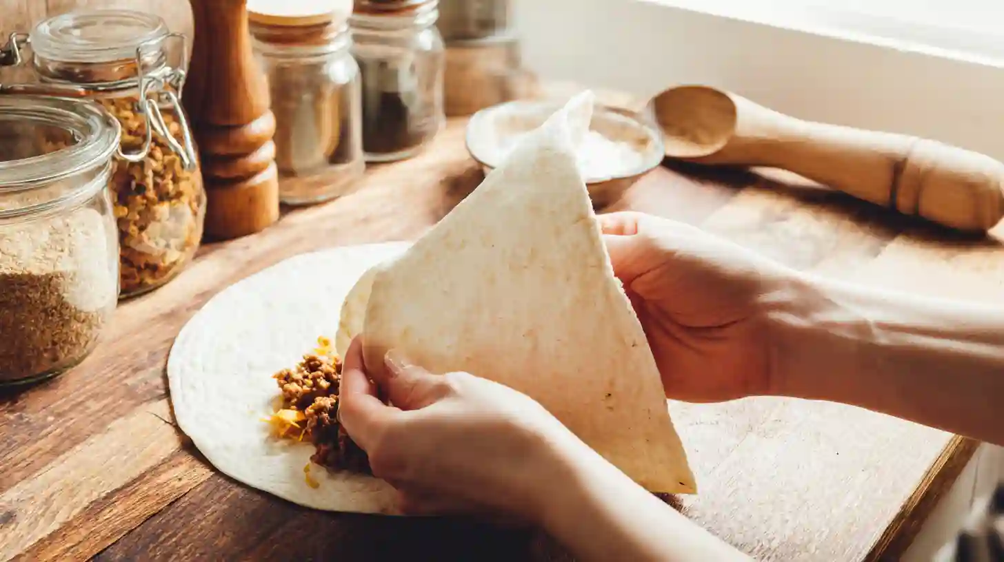 fold-roll-nacho-cheese-beef-wrap Folding and rolling a nacho cheese beef wrap for meal prep