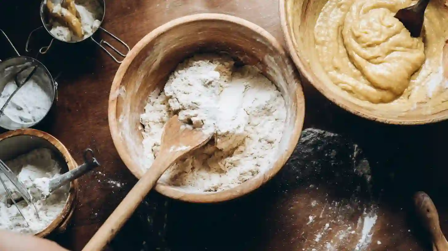 folding-dry-into-wet-cookie-bar-dough mixing classic dry ingredients for homemade desserts that sell well