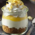 Garnished No Bake Lemon Cheesecake Parfait topped with whipped cream and lemon