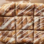 Drizzling glaze over Cinnamon-Sugar Pizza made with Crescent and slicing into warm squares—easy crescent roll dessert recipe for families and 30-minute sweet snacks.30-minute sweet recipe