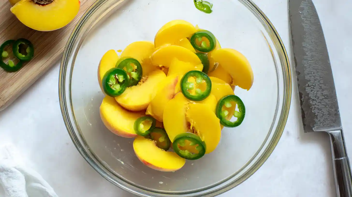 peach-jalapeno-bowl-prep Sliced peaches and jalapeños tossed together in a bowl