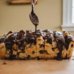 Drizzling rich chocolate glaze over Pull Apart Cookie Dough Cheesecake Loaf – perfect for best homemade baking ideas and budget-friendly desserts for families.
