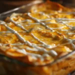 Buffalo Chicken Lasagna with a Ranch Twist resting before slicing with ranch drizzle