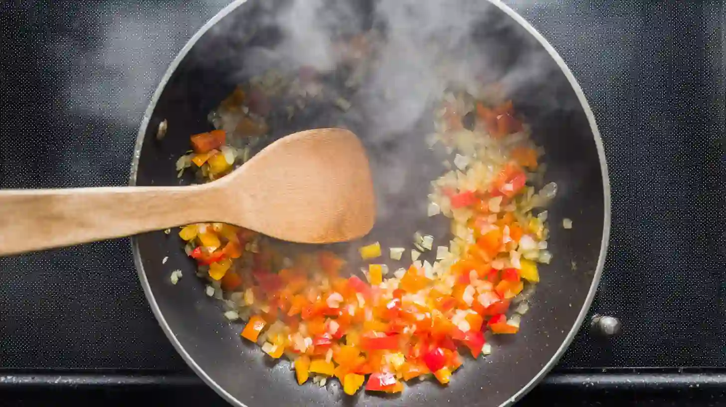 saute-onion-bell-pepper-taco-spaghetti Onion and bell pepper sautéing in olive oil for taco spaghetti