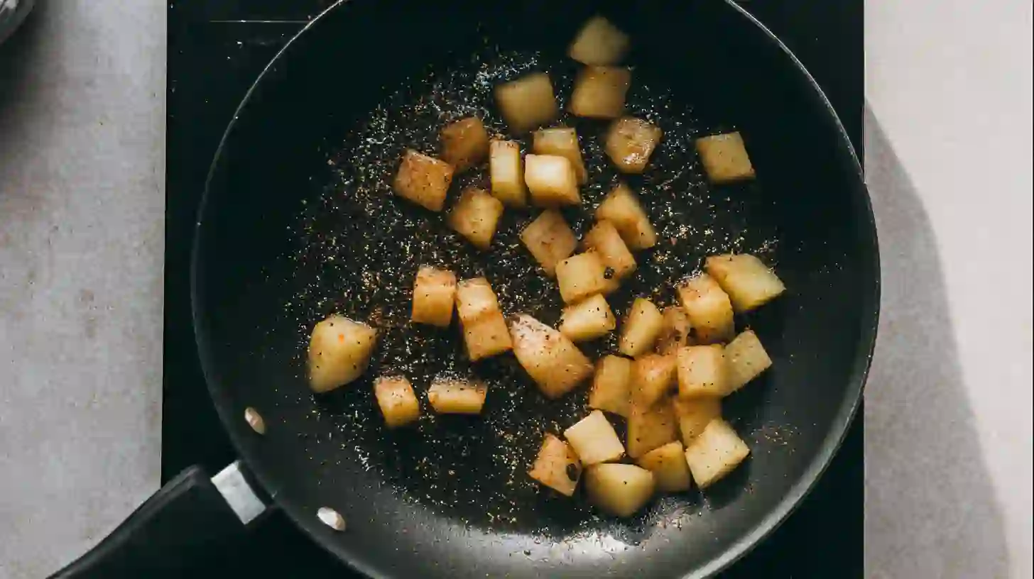 step1-diced-potatoes-olive-oil-paprika diced potatoes cooking in olive oil with paprika in skillet