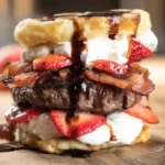 Stacking the Bacon Strawberry Shortcake Burger with whipped cream and strawberries – best bacon and berry burger idea for summer family dinners