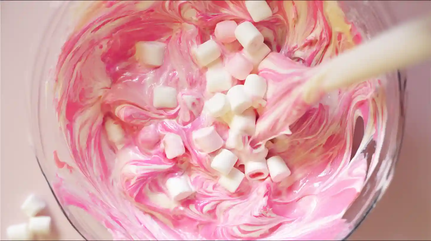 bubblegum-cloud-fudge-step4-fold-marshmallows Folding marshmallows into Bubblegum Cloud Fudge recipe, a pink fudge dessert and easy dessert recipe for families