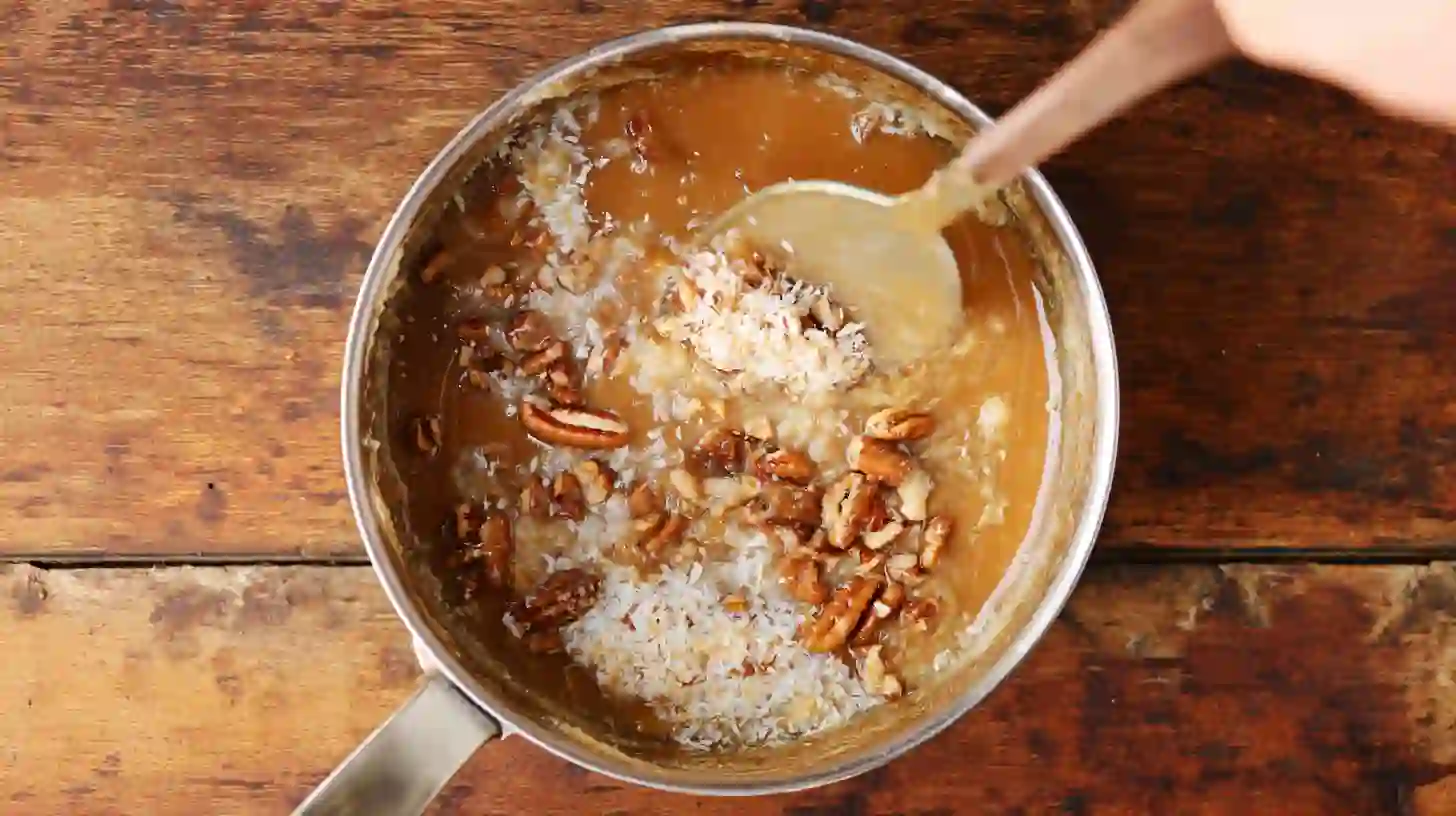 coconut-pecan-buttermilk-cake-step5-make-frosting Coconut Pecan Buttermilk Cake recipe step – frosting made by melting butter, brown sugar, and milk with coconut and pecans for holiday cake recipes with coconut