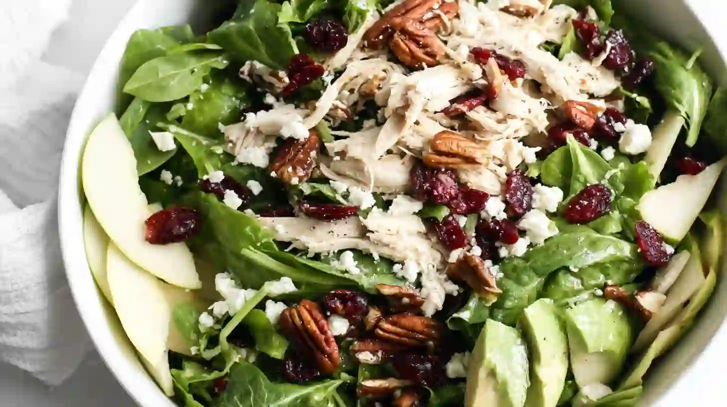 cranberry-pecan-chicken-salad-step1-build-base Healthy cranberry pecan chicken salad recipe with fresh greens, rotisserie chicken, cranberries, and toasted pecans – perfect clean eating lunch
