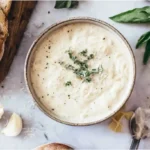 Homemade Alfredo Sauce with Parmesan, bread, and pasta