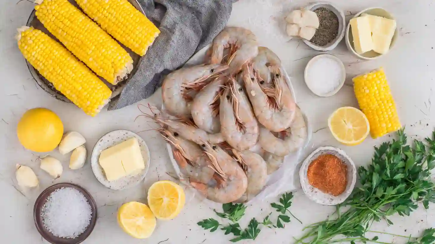 garlic-butter-baked-shrimp-with-corn-ingredients-Image Fresh ingredients for Garlic Butter Baked Shrimp with Corn – shrimp, corn, butter, garlic, parsley, and lemon