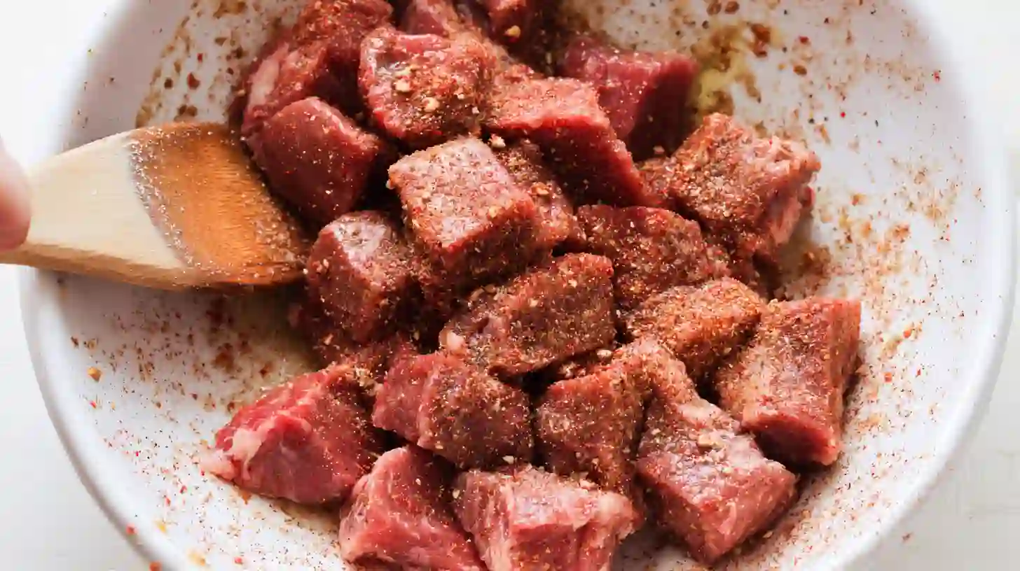 seasoning-steak-bites-cajun-garlic-butter Seasoning sirloin cubes with Cajun spice and garlic butter mix for cheesy garlic steak bites and creamy linguine, best skillet steak recipe for families