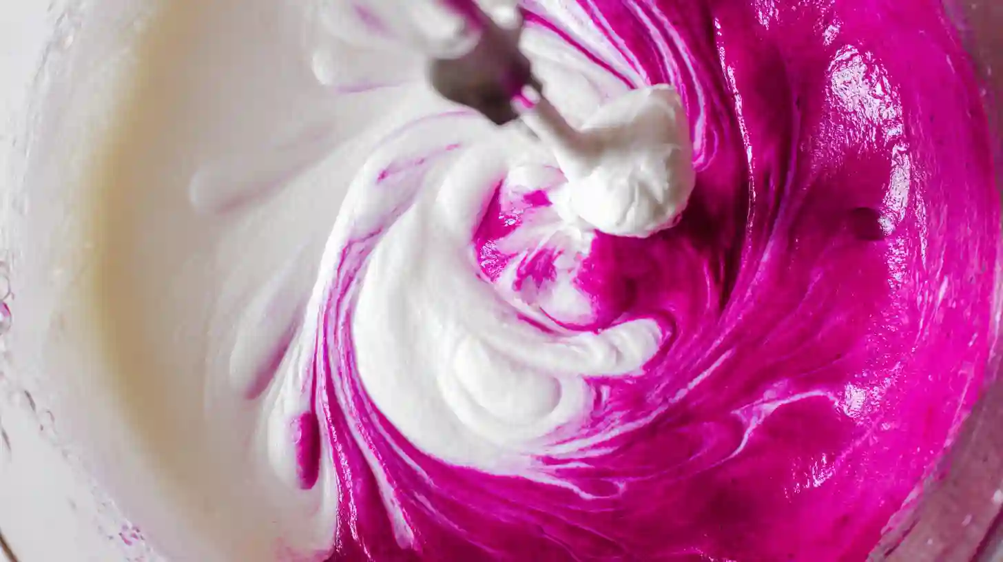 step-3-mixing-dragon-fruit-ice-cream Mixing dragon fruit puree with whipped cream for dragon fruit ice cream homemade, a step in healthy homemade ice cream recipes