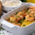 Garlic butter baked shrimp and corn garnished with parsley and served with bread and rice