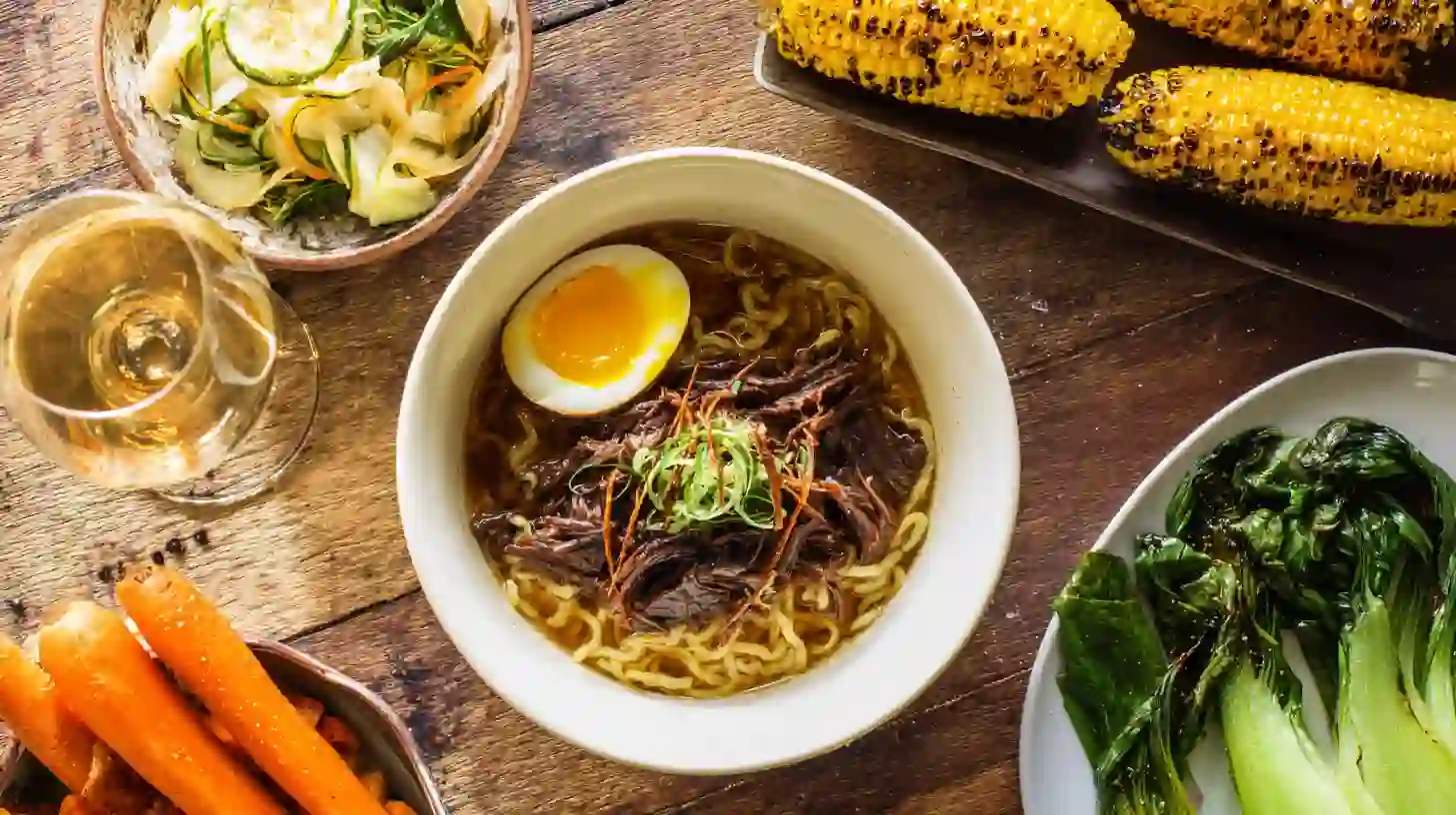 serving-oxtail-ramen Serving Oxtail Ramen with salad, vegetables, garlic butter corn, and wine – winter oxtail soup ramen and easy dinner recipes for families
