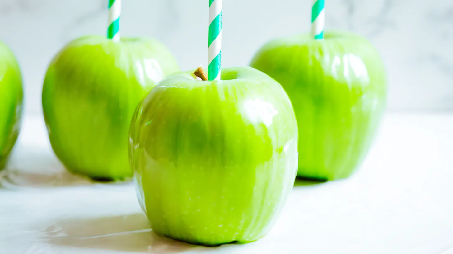 Strawberry shortcake caramel apple recipe – Granny Smith apples with decorative sticks inserted, ready for homemade gourmet apples and seasonal fruit dessert recipes.