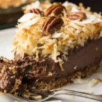 Serving no-bake German chocolate pie perfect dessert topped with shaved white chocolate and pecans, quick chocolate pie recipe and family-friendly no bake desserts