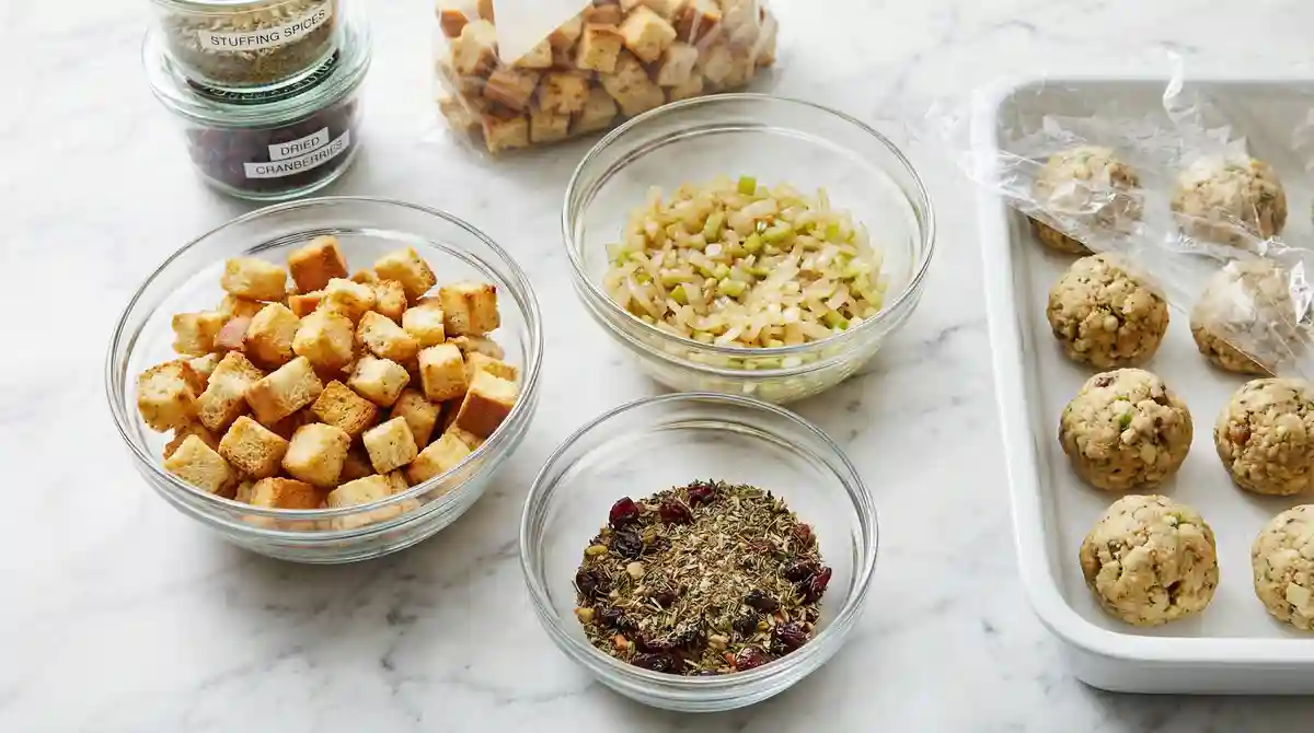 Make-ahead stuffing ball preparation with toasted bread, sautéed vegetables, dry herb mix, and formed stuffing balls in airtight containers