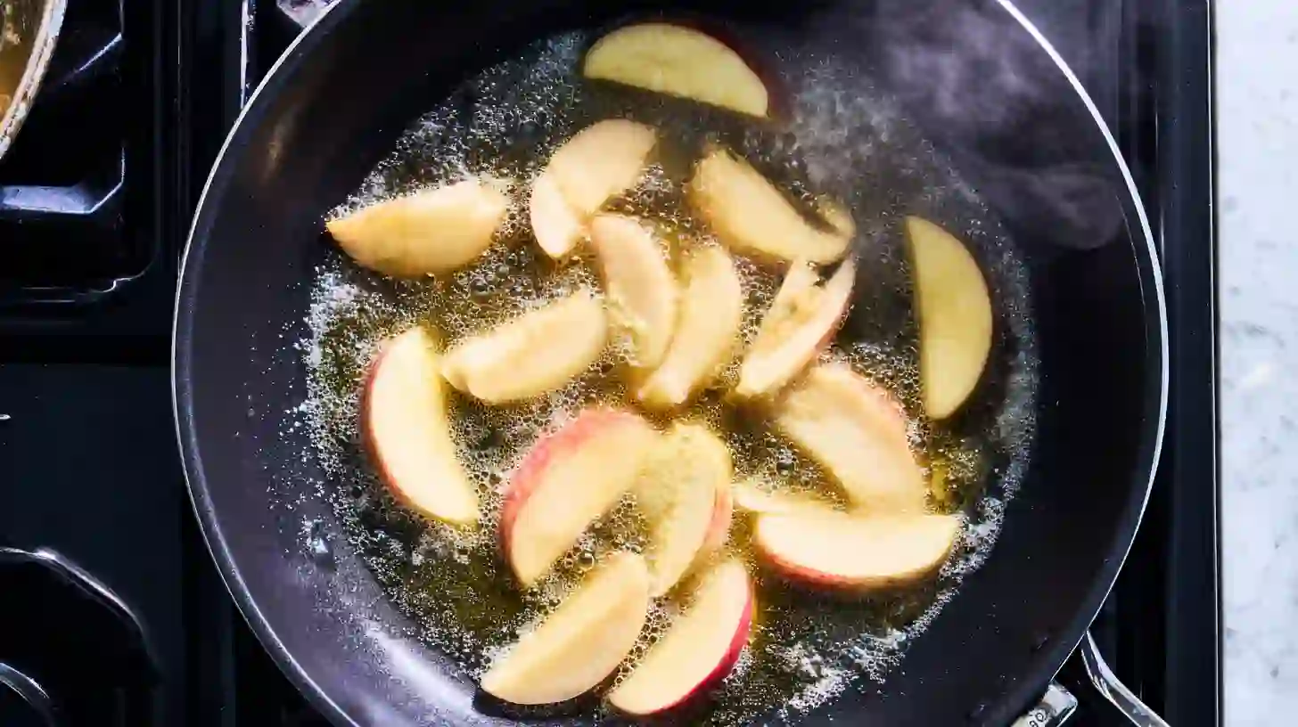 Sautéing Honeycrisp apples in melted butter for golden baked brie holiday appetizer recipe