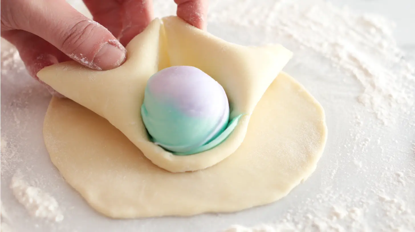 step3-fill-and-seal-cheesecake-bombs Filling cotton candy cheesecake bombs with whipped cream cheese for deep fried desserts and sweet snack recipes for kids.